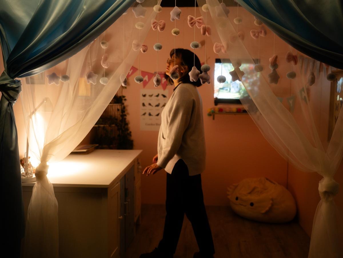 A player exploring Saya's softly lit room